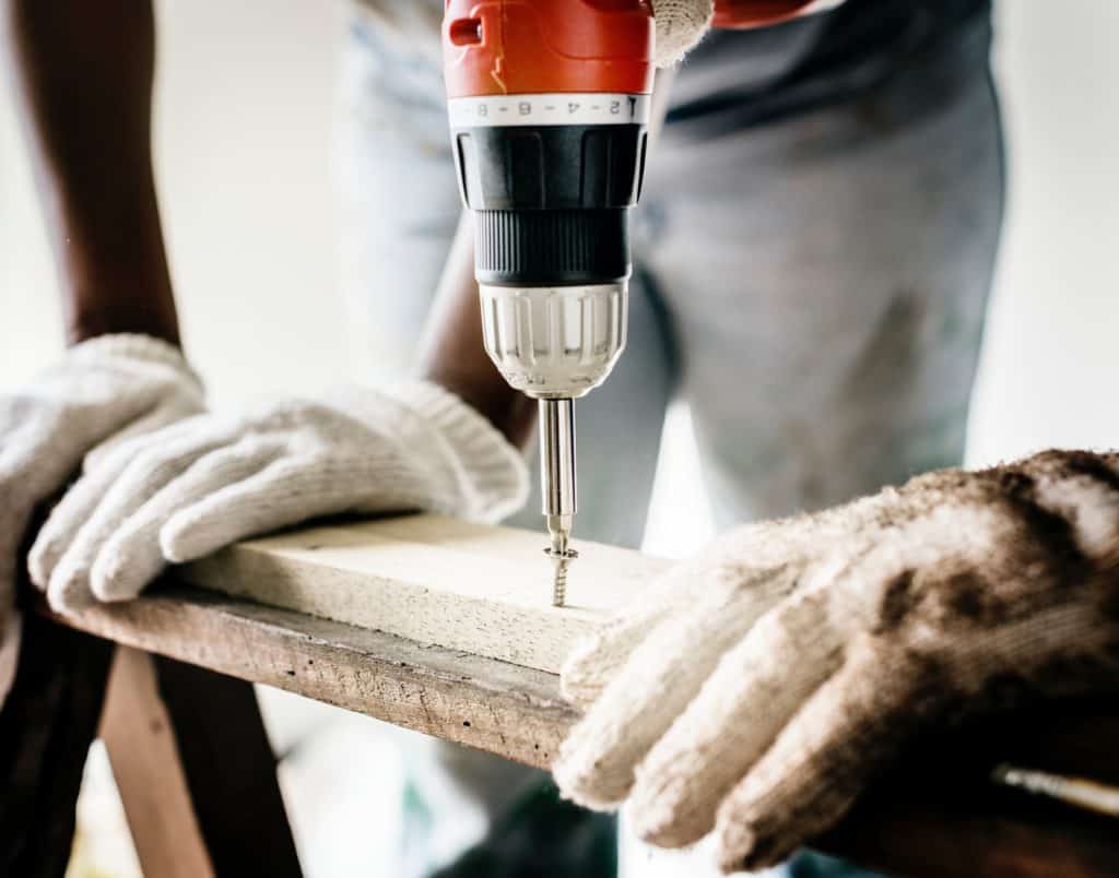 person drilling wood