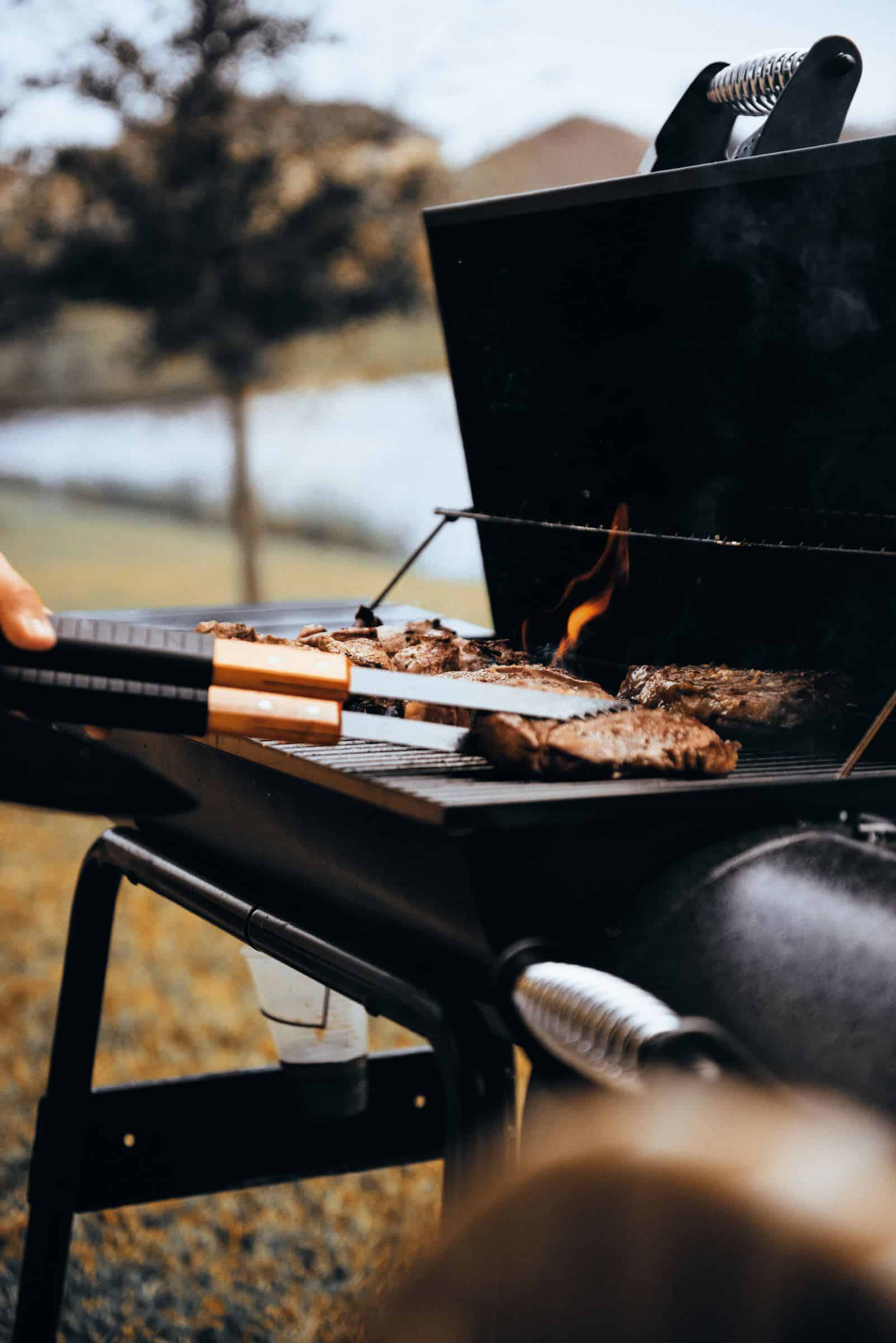 someone is grilling the meat