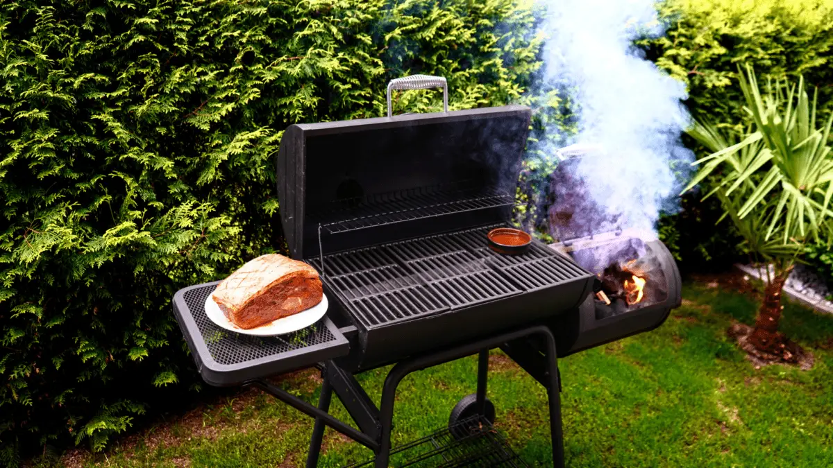 open pellet smoker in a yard